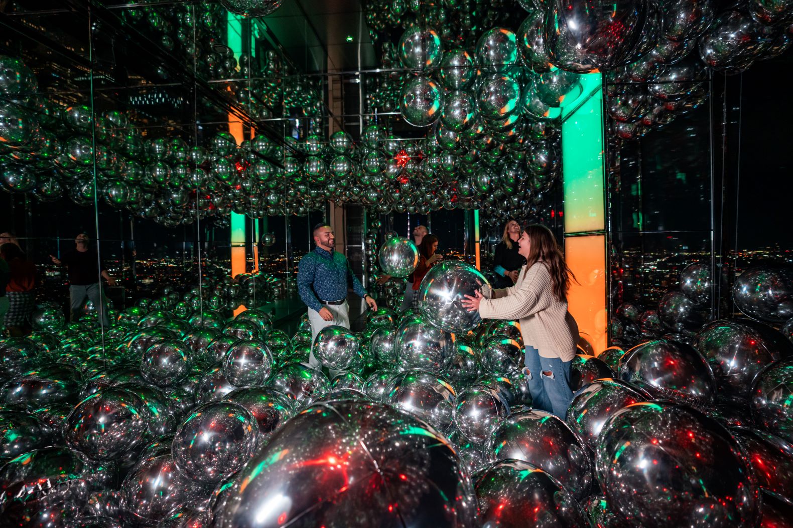 Affinity at night with guests enjoying the "floating orbs"